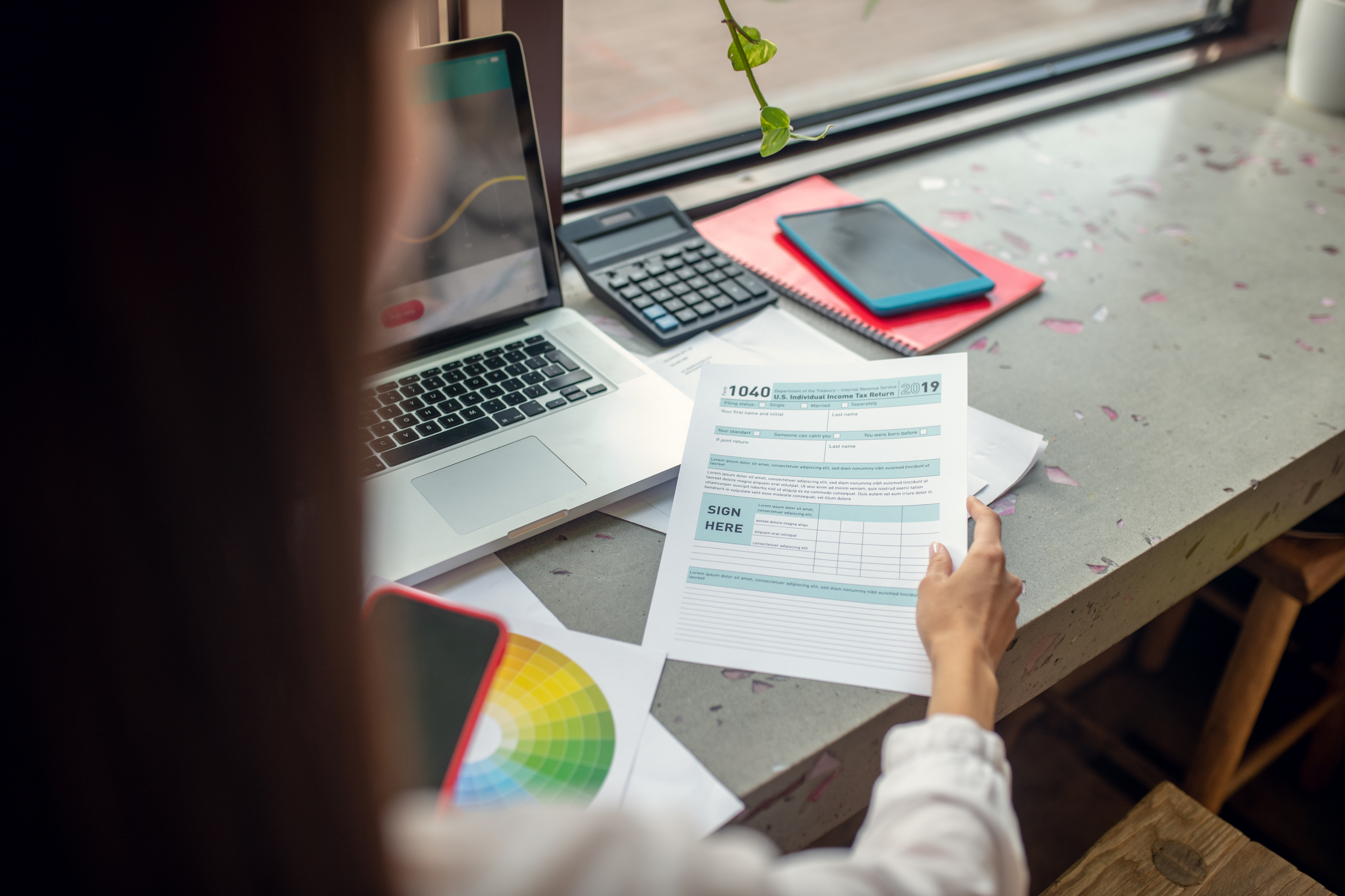 Close up of businesswoman filling personal tax declaration